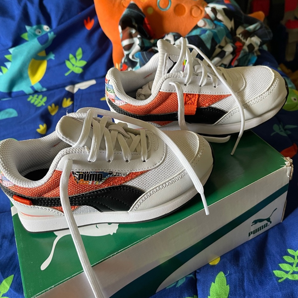 Pumas size 13. White, with black and orange design.